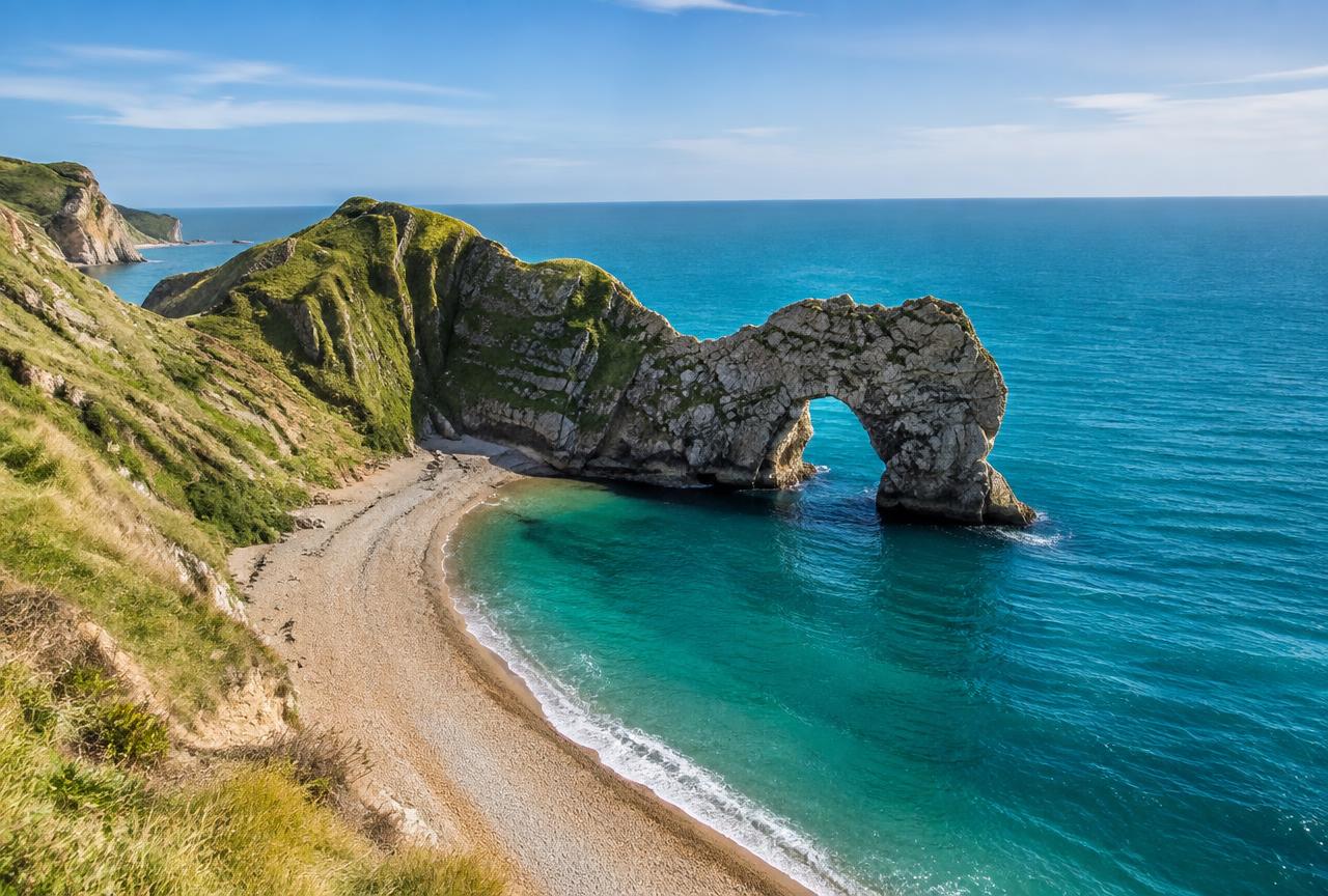 Durdle Door limestone arch above turquoise sea on a private Jurassic Coast tour from London