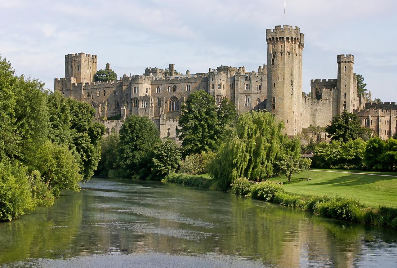Warwick Castle towers above the River Avon on a private Warwick and Stratford tour from London